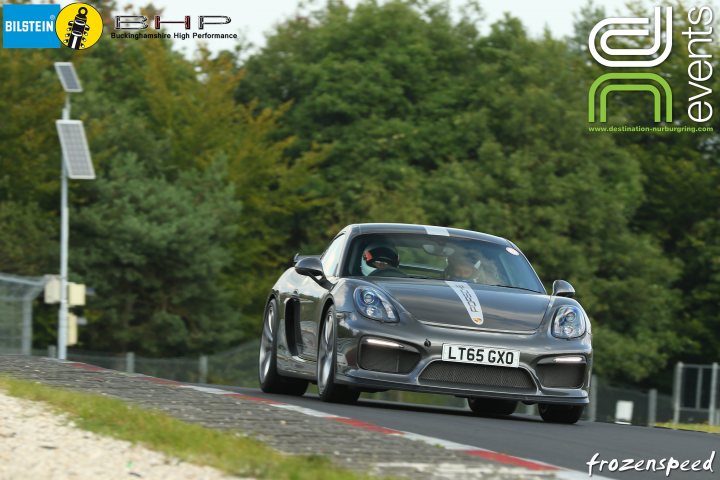 Porsche Cayman GT4  - Page 5 - Readers' Cars - PistonHeads - The image captures a silver race car in motion on a curved track, set against a backdrop of lush greenery and under an open sky. The car is identifiable by a prominent "L66 GTX" emblem on the side. There's a clear watermark across the image that reads "FROZENSPEED". The car is positioned closer to the viewer on the left side of the image, giving a sense of forward movement.