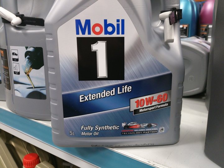 DB9 engine ticking noise - help please - Page 4 - Aston Martin - PistonHeads - The image shows a product that is likely a type of motor oil. This is indicated by the text and associated imagery on the container. Specifically, the label reads "Mobil" which is a well-known brand of motor oil, and the product is labeled as "Extended Life," suggesting high performance and longevity for the engine it's meant to serve. The container also mentions the viscosity as "10w-60" and "Fully Synthetic," implying it's designed to work in various conditions and that the oil has been derived from synthetic components. The cap of the container is partially visible, hinting at the packaging and overall design of the product.