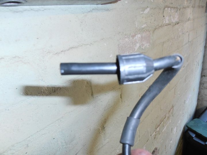 A black and white photo of a white toilet - Pistonheads - The image shows a close-up view of a metallic object, resembling a scrap or a piece of waste metal. It appears to be made of aluminum and looks like a weapon, possibly a stun gun, due to its shape and the presence of a steel pipe or rod with a black gripping section. The background consists of a concrete or brick wall, hinting at an urban or industrial setting. The focus of the image is on the metallic object, with the background being less distinct and out of focus.