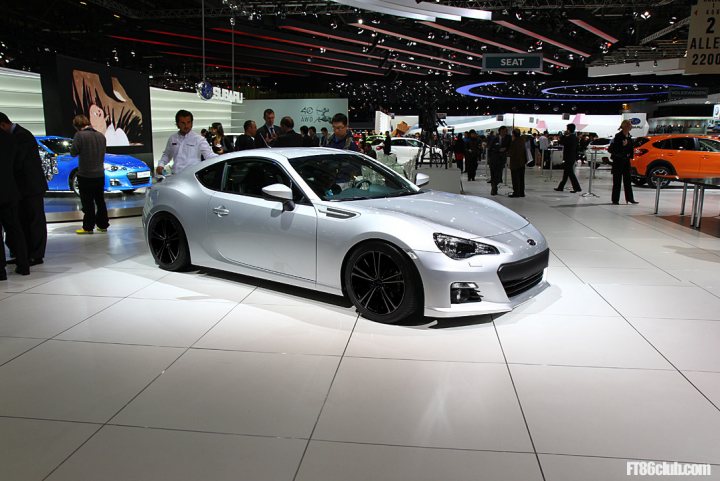 Pistonheads - The image shows an auto show with a silver sports car on display. The car is positioned on a stage illuminated by spotlights. In the background, other cars and attendees can be seen. The car's design suggests it is a sporty, likely premium brand model. The show seems to be indoors with a focus on presenting the vehicle in an elegant and inviting setting.