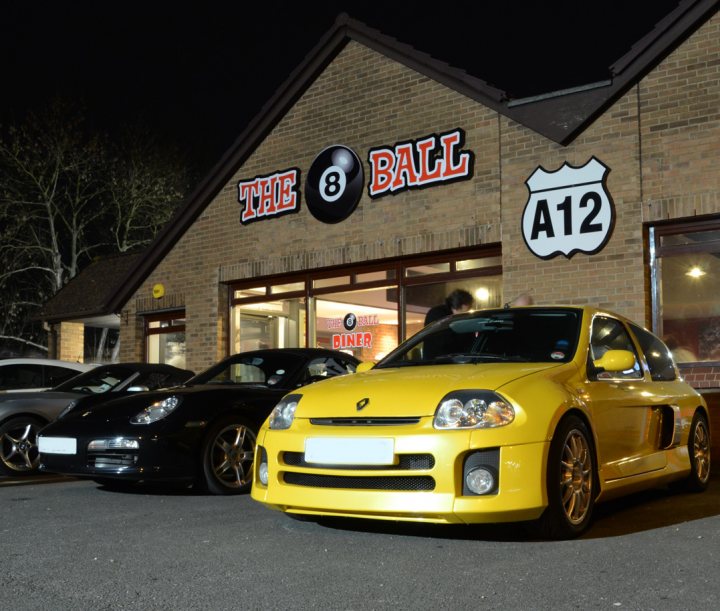 March Essex Pistonheads - The image captures a lively scene at a sports car racing business. The building prominently displays "THE 8 BALL" in large, bold letters and also indicates "A12", suggesting it might be located near state route A12. Outside the building, two more black sports cars are parked, adding to the intensity of the racing environment. Some people can be seen, possibly customers or staff, walking around, suggesting the location is open and operating.