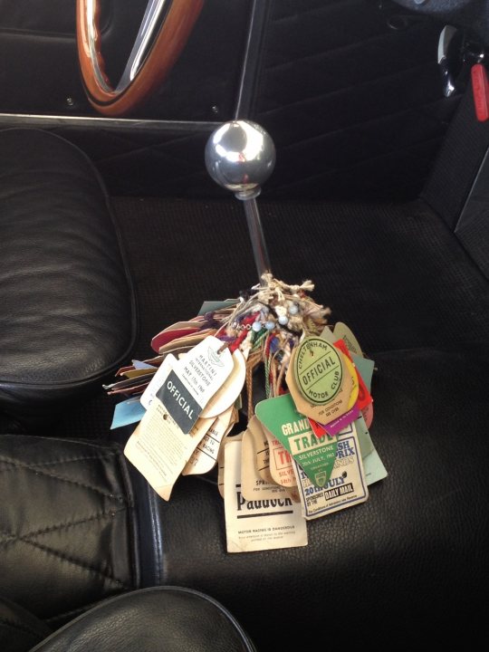 A table topped with lots of different types of items - Pistonheads - The image showcases the interior of a vehicle, specifically the seat. A keyring dangles from the rearview mirror, catching light and creating an array of colors and shapes. The keyring is adorned with numerous old keys, each varying in size, length, and shape. The background reveals a black seat with stitching, emphasizing the contrast between it and the vibrant keyring.