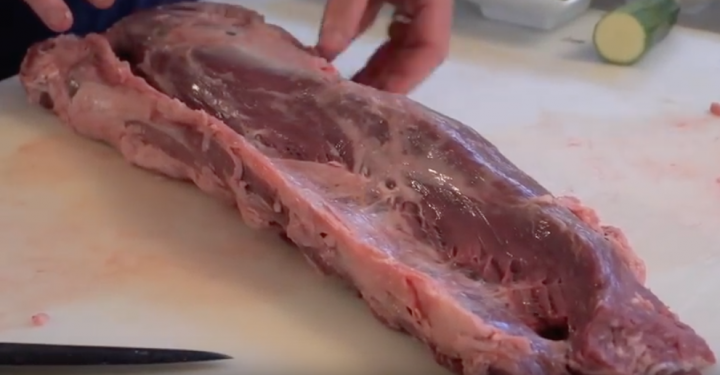 THE  STEAK THREAD, served a la Man. - Page 55 - Food, Drink & Restaurants - PistonHeads - The image shows a person in the process of cutting or preparing meat, specifically pork ribs. They are using a knife to slice through the bones and flesh of the ribs. The ribs are on a flat surface with a cutting board underneath them. The person appears focused on their task, with one hand holding the knife steady while the other is applying pressure to cut through the meat. There's an uncooked carrot visible in the background, indicating that this might be happening in a kitchen or cooking area.