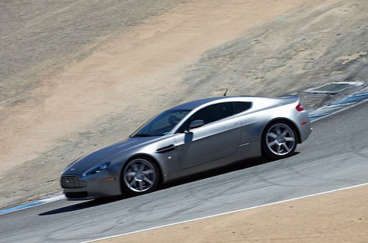 So what have you done with your Aston today? - Page 136 - Aston Martin - PistonHeads - The image shows a silver sports car on a race track. The car is positioned on the inside of a turn, indicating speed and control. The setting suggests a high-performance driving environment. There are no visible passengers in the car, focusing the attention on the vehicle's performance. The car is equipped with alloy wheels and a distinctive front design, characteristic of high-end sports cars.