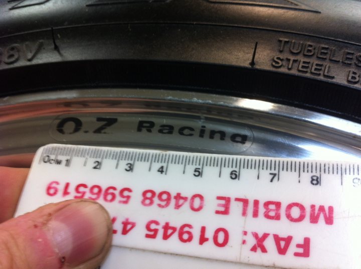 My 1992 Griffith 400 (250) - Page 1 - Griffith - PistonHeads - The image shows a manual tire pressure gauge laid out next to a bottle. The gauge has a red fingerprint smudge on it, and its brand reads "OZ RACING." There are markings on the gauge that specify different tire pressure levels, ranging from 0 to 4 meters, presumably of water, a common unit for tire pressure. The gauge appears to be dirty, indicating it has been used. The bottle's label is not visible.