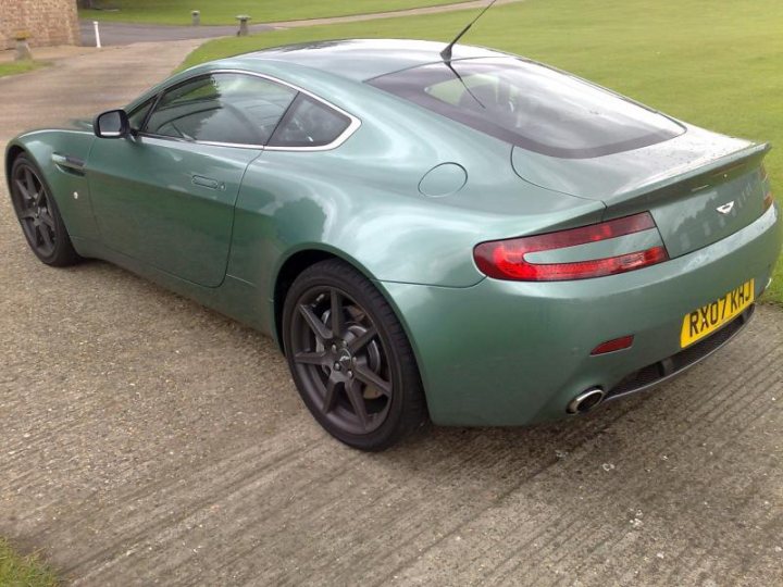 Pistonheads Dbs Green - The image shows a green sports car parked on a driveway or sidewalk. The car appears to be a model with a small rear spoiler, and it is equipped with dark-colored alloy wheels. The license plate reads "R60," which might be a model name or a tagline specific to the car. A small part of the car's interior is visible through the driver's side window, suggesting that the car could be accessorized with the latest technology and creature comforts.