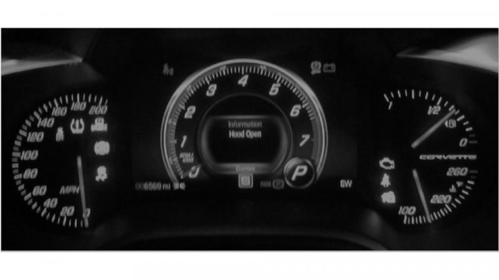 A close up of a black and white clock - Pistonheads - The image depicts the dashboard of a car at night, with the lighting creating a stark contrast. The dashboard is filled with various lights and displays, including speedometer, fuel gauge, temperature gauge, and a digital display for vehicles with connected systems. The car's navigation system is also visible, showing a route with the text "navigation display on screen." The dashboard includes indicators for a passenger side mirror and turn signals.