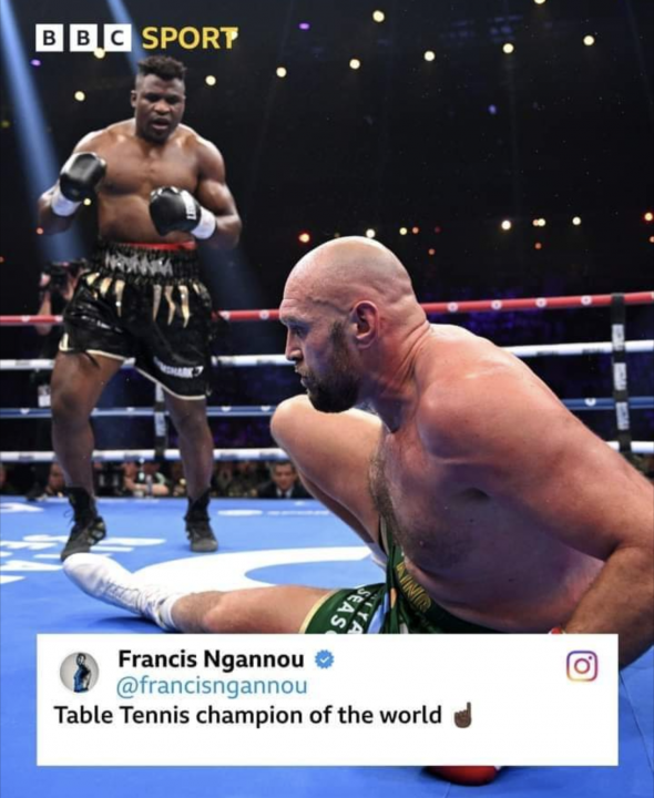 Pistonheads - The image shows a boxing match in progress. One boxer is standing upright in a black and gold trunks, while another boxer is on the floor. The standing boxer is wearing gloves and is????ly jumping up and down. A tweet appears at the bottom with a user named Francis Ngannou.