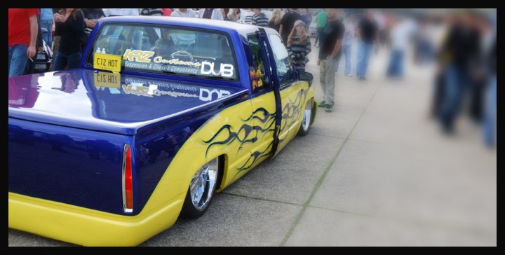 Pistonheads Truck Chevy - The image captures a scene of a crowd gathered around a customized blue truck parked on a concrete surface. The side of the truck is adorned with stylized graphics, adding to its unique appearance. On the back of the truck, there is a yellow bumper and a tailgate that features more of the same intricate designs. On the windshield, the truck is covered with decals that read "KRF" and "KRF Custom ZZ6R". The truck appears to be a ZZ6R with a raised cab and a bed liner, hinting at the owner's customizations and perhaps a penchant for tough trucks. The presence of other individuals in the background suggests that this could be a display or a gathering related to the truck or others like it.