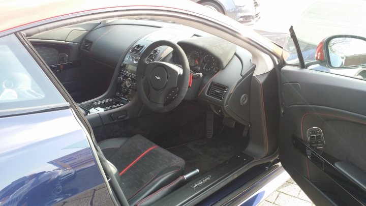 A car is parked on the side of the road - Pistonheads - The image showcases the interior of a luxury car, with a focus on the driver's seat. The photograph is taken from the back seat, capturing the car's rear view and front passenger door. The car is equipped with a leather seat, and the dashboard features a digital readout. The cabin of the car displays a sleek and modern design, indicative of a high-end luxury model.