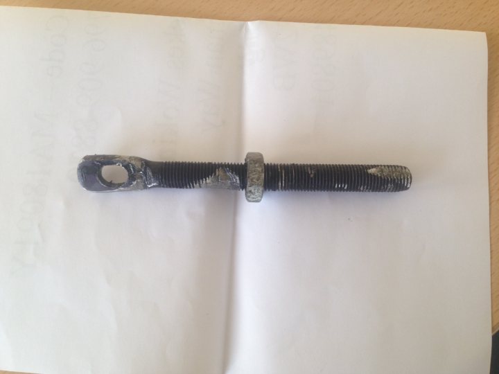 Can someone help me - What is this part? - Page 1 - Home Mechanics - PistonHeads - The image shows a metal object, which appears to be a tool like pliers or a similar mechanical device, resting on a white piece of paper. The object is in an open position, revealing a threaded shaft and a triangular attachment at the other end. The object is dirty and rusted, indicating it has been exposed to moisture and dirt for some time. The paper the object rests on appears to be a piece of office paper, which suggests the photo may have been taken on a desk or workspace.