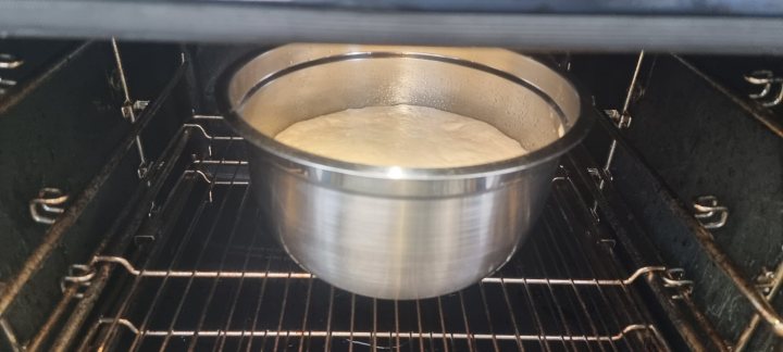 A close up of a pan of food on a stove - Pistonheads - The image captures a culinary scene in progress. In the center, a metal bowl filled with batter sits on top of an oven, suggesting that it might be preparing for baking. The oven itself is open, revealing its interior and hinting at the heat inside. On either side of the bowl are two pans, each containing food items; to the left is a tray with a single piece of meat or fish, while to the right is another pan with what appears to be a cake or similar baked item. The oven and the cooking process are the primary focus of the image, indicating that this could be a snapshot from a professional kitchen or someone preparing for a large meal.