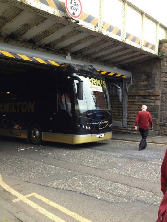 Just passed my PCV test - Page 1 - Commercial Break - PistonHeads - This image captures a moment of unexpected adventure on a bridge in Scotland. A double-decker bus, possibly touring or a part of a larger event, is driving under the bridge. The bus is massive, taking up a large part of the image. Amidst the bustle, there's a solitary figure bravely walking in front of the bus, adding to the drama of the scene. The background features the sturdy structure of the bridge and a hint of a Scottish landscape.