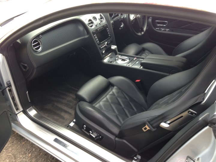 I’ve put my football boots on & bought a Bentley GT Speed - Page 1 - Rolls Royce & Bentley - PistonHeads - The image shows the interior of a luxury car, focusing on the backseat. The seats are upholstered in black leather, and they feature a diamond quilt pattern on the center and backrest. The interior surfaces, including the dash and center console, also appear to be in black, contributing to the car's sleek and opulent aesthetic. The vehicle appears to be parked, with daylight illuminating the interior, suggesting an outdoor setting.