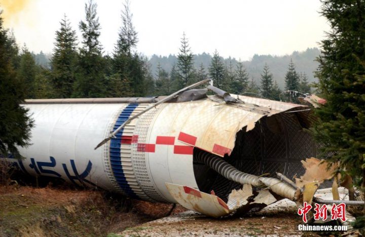 Pistonheads - The image shows a striking scene of a heavy-duty pipe or cylinder that appears to be a section of a missile or space vehicle. The pipe is attached to a cylindrical body, also consisting of pipe sections, and both show signs of being involved in a serious incident, given the flattened and damaged area with exposed insides. The damage suggests a high-energy collision or explosion. The surrounding environment is a forested area, indicating the scene could be a crash clearing or off-site handling location.