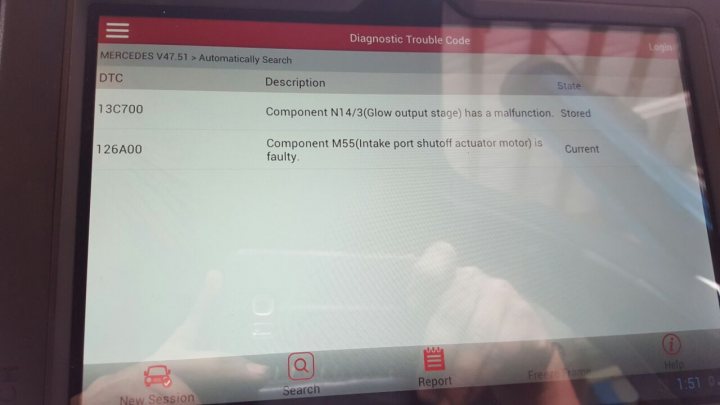 C350cdi 2010 v6 Not Starting, Constant fuse 23 blow. - Page 1 - Home Mechanics - PistonHeads - The image is a photograph taken from the view of a person using a computer or device. The device screen displays a diagnostic error, specifically a "Diagnostic Trouble Code" with the description "13C700. Component N143(Glow output stage) has a malfunction. Stored." Below that, there's a "Component M55 Intake port shutoff actuator motor" followed by "Current." The F1 and F2 indication tabs are displayed, as well as icons labeled "NEW SESSION," "QUESTION," and "REPORT," along with "Search" and "Report" tabs at the bottom. The image captures a part of the computer screen with the error message on it. The specific model being diagnosed is a Mercedes V225, which is often associated with automatic transmission.