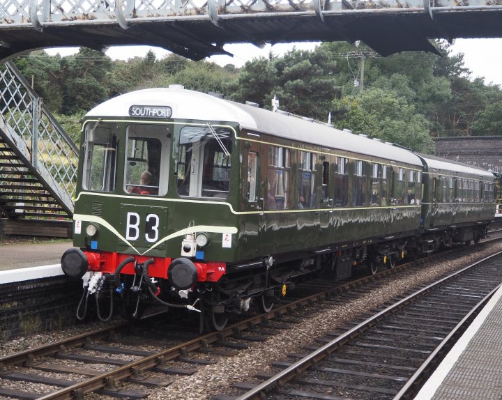 Pistonheads - The image showcases a vintage train car, painted in an elegant combination of green and cream. It's parked on the tracks, adding a touch of nostalgia to the scene. The car proudly displays the number 3 on its side, standing out against the two-tone color scheme. In the background, a brick bridge stretches over the train, providing a contrasting backdrop to the vehicle. A solitary figure can be spotted near the tracks, perhaps waiting for the train's departure or simply admiring this charming relic of railway history.