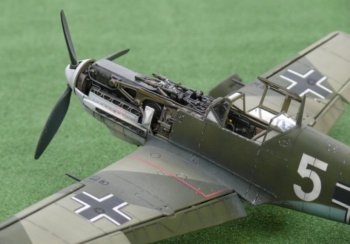 Latest Project: Matchbox 1/32 Bf-109E-3 - Page 16 - Scale Models - PistonHeads - The image showcases a meticulously detailed model of a German World War II plane, complete with its propellers, anti-aircraft guns, and distinctive camouflage painting. The aircraft is adorned with a number "5" on the side of the fuselage. It is carefully mounted on a vibrant green artificially grassed base. Uniquely, small toy figures can be seen inside the cockpit, adding a playful and creative touch to the realistic setting.