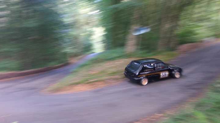 Pistonheads - The image depicts a scene of an individual riding a dirt bike on a curvy trail. The rider is dressed in full protective gear, emphasizing safety precautions while engaging in this activity. The environment is lush with greenery and dense vegetation, indicating that the trail is likely within a forest or a similarly natural setting. The motion of the bike is captured as it navigates one of the sharp turns on the trail. The image does not contain any text or other distinguishable features that would require further elaboration.