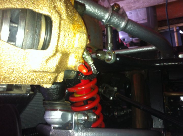 A close up of a blender on a table - Pistonheads - The image shows a close-up view of the suspension system of a vehicle. A belt on the car appears to be red and possibly covered in grease. There are metals surrounded by springs, possibly part of the engine or transmission system. The photo seems to have captured movement, as there are blurred components behind the primary focus. It appears to be an under-car photo, showing mechanical parts that might be related to the vehicle's suspension or engine.