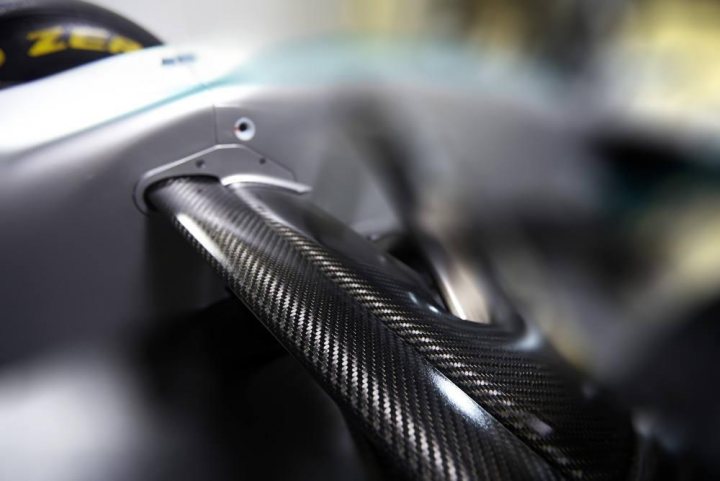 A close up of a person holding a pair of scissors - Pistonheads - The image is a close-up photograph of a carbon fiber component, likely within a machine or vehicle based on its structure. The material has a distinctive black and white woven pattern indicative of carbon fiber construction. The focus is soft, giving a gentle blur to the surrounding area, and this blur appears to be a interior white wall, suggesting that the main object might be a piece of anycar parts. The photograph has a shallow depth of field, focusing sharply on the fibers of the carbon fiber, while the rest of the image blurs. There are no texts or additional elements visible within the scene.