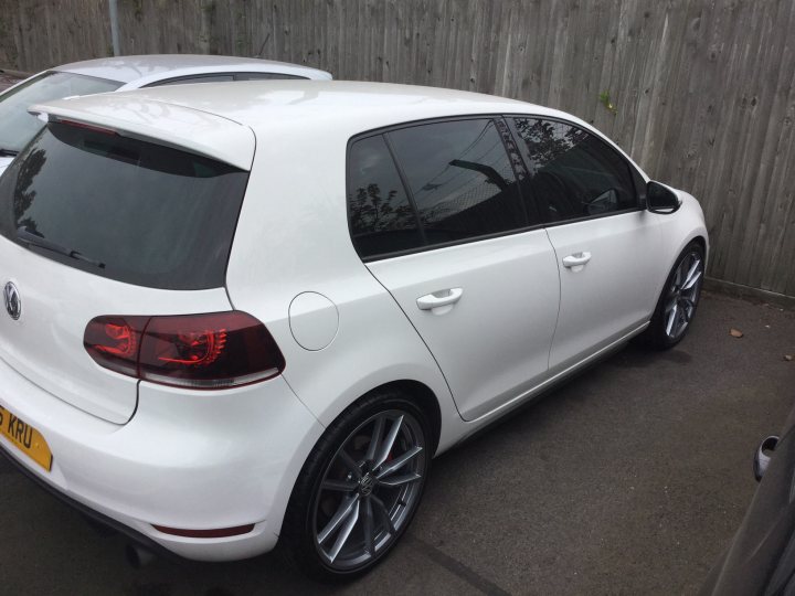 MK6 GTI ON 19" GOLF R ALLOYS - Page 1 - Audi, VW, Seat & Skoda - PistonHeads - The image shows a white VW Golf parked outdoors. It's a sunny day, and the car is positioned beside a wooden fence. The Volkswagen's body is clean and shiny, indicating either a new vehicle or one that has been well-maintained. The license plate clearly visible with the text "B10 KTH" suggesting its registration details. It appears to be in good condition, with no visible damages or wear.