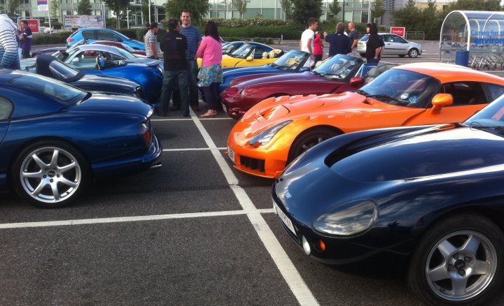 A group of cars are parked in a parking lot - Pistonheads