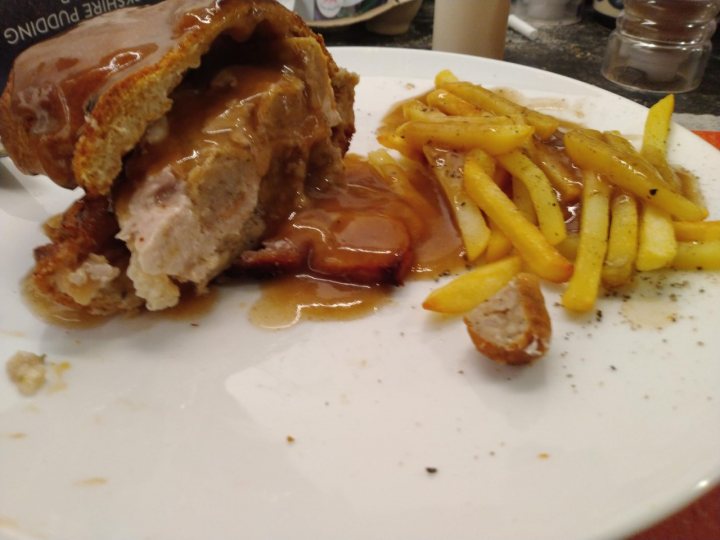 A white plate topped with a sandwich and fries