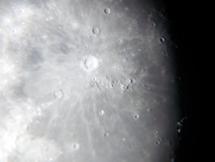 Photographing the moon - Page 1 - Photography & Video - PistonHeads - The image provides a dynamic view of a celestial body, most likely a moon or a planet with a white cloud-like texture that suggests a frothy or iridescent surface. It appears to be taken at a high angle, capturing the curvature of this celestial object. Along the edges of the image, there are darker areas that represent shadowed regions, potentially indicating the presence of terrain features such as craters or depressions. The overall image has a close-up quality and conveys the rugged and craggy nature of the body in the frame.