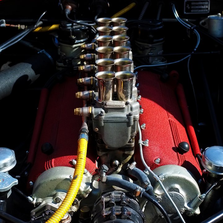 Sunday Meet Anyone? - Page 1 - South West - PistonHeads - The image shows a close-up view of the engine bay of a vehicle. The engine is composed of multiple cylinders with chrome, red, and silver components. Bolts and valves are visible, and there are yellow and black tubes running through the scene. It appears to be a vintage or collectible vehicle, judging by the design and condition of the engine.