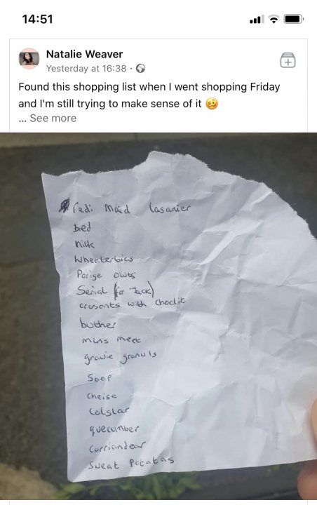 Facebook fails Vol. 2 - Page 143 - The Lounge - PistonHeads - The image is a screenshot of a smartphone displaying a photo of a handwritten shopping list. A person is shown holding the paper with their face visible, though only the top part is seen due to the cropping of the photo. The text on the paper appears to be in English and includes various items such as "bed," "crisps," "toiletries," "pancakes mix," "chocolate," "vegetables," and others, totaling fifteen items. The overall context suggests that this is a personal shopping list for someone who has left it on the floor of a shop or an outdoor location.