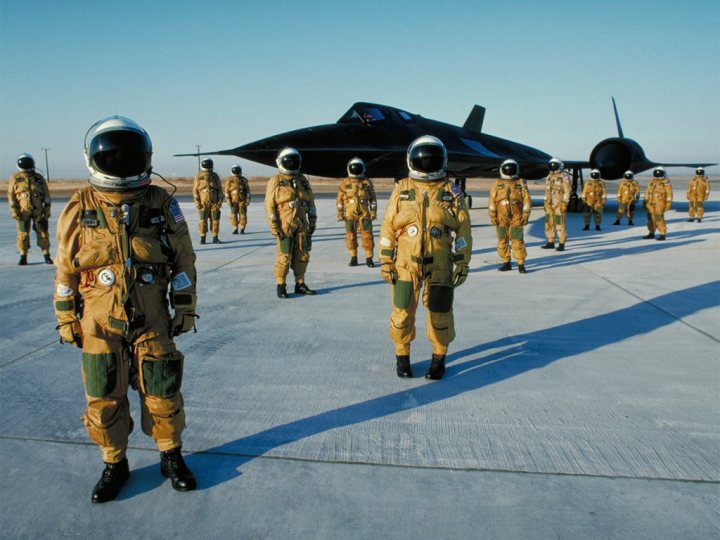 Post amazingly cool pictures of aircraft (Volume 2) - Page 422 - Boats, Planes & Trains - PistonHeads - The image presents a scene at an airfield where a group of military personnel are preparing for a mission. There's a fighter jet in the background, suggesting that they are about to embark on a flight. The soldiers are dressed in camouflage uniforms with helmets, indicating that they are ready for action. They are gathered around what appears to be an open briefcase case, possibly containing important mission documents or equipment. This scene captures the essence of military readiness and preparation for a specific task.