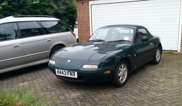 Where to start? - Page 1 - Mazda MX5/Eunos/Miata - PistonHeads - The image features a vibrant green Fiat 500 sport in the foreground, parked on a bricked driveway. Behind it, a silver car is also parked, both vehicles facing us. A garage door is visible in the background, partially obscured by the cars. There are no visible texts or distinctive marks. The scene presents a typical residential setting.