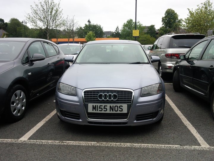 What crappy personalised plates have you seen recently? - Page 488 - General Gassing - PistonHeads - The image depicts a parking lot where several cars are parked. Dominating the foreground is a small gray Aud car with a registration plate reading "MI55 NOS". Parked perpendicularly to it is a black car. The cars are parked on pavement marked with white lines, and the background includes a few other vehicles and a clear sky. The photo captures a bright day with ample natural light illuminating the scene.