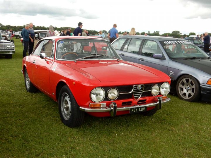 A classic car is parked in a field - Pistonheads