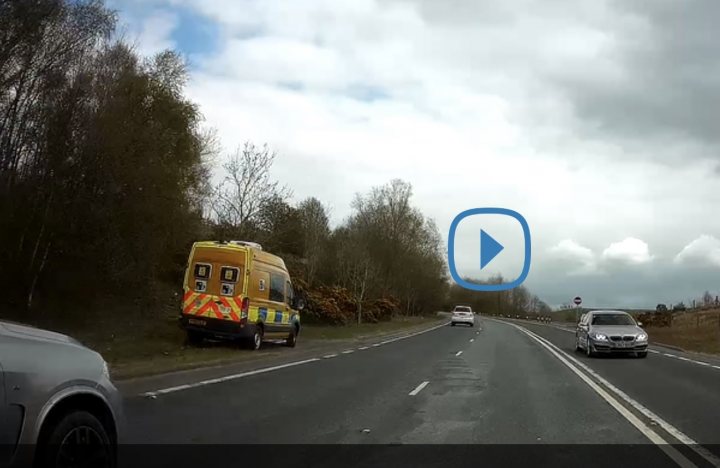 Speed camera van with hatches shut - Page 1 - Speed, Plod & the Law - PistonHeads UK - The image depicts a scene from inside a car, capturing the perspective of a driver. In front of the car, there is a truck parked or moving slowly on the street. There's an open sky above, suggesting it might be early morning or late afternoon due to the soft light. On the right side of the image, there's a traffic light visible, indicating a controlled intersection ahead. The road appears to be in a suburban area with some trees and foliage on the sides, adding to the peaceful, everyday nature of the scene.