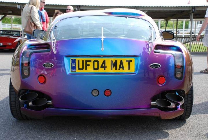 Sunday Supercar Pistonheads - The image features a beautiful, deep purple or blue convertible car parked on an asphalt surface. The car is unmistakably a Ford UFO4, identifiable by the license plate that reads "UFO4 MAT." This vibrant vehicle dominates most of the frame, capturing the viewer's attention.

In the background, there is a man seen walking by, adding a human element to the scene. The overall setting appears to be an outdoor parking area, as suggested by the open sky visible in the distance. The image presents a striking contrast of colors and textures, from the glossy finish of the car to the man's casual attire and the more subdued background.