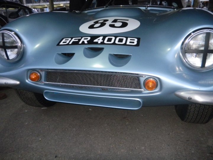 Early TVR Pictures - Page 126 - Classics - PistonHeads - The image features a vintage sports car that is predominantly blue in color. The vehicle is facing directly towards the camera, with a distinct white stripe running down the center. On the front, there's a black and white license plate, which reads "BFR 400B". The front of the car is adorned with three round headlights, two one the left and one on the right, and two circular orange indicator lights. The car appears to be situated in an outdoor environment, likely a parking area.