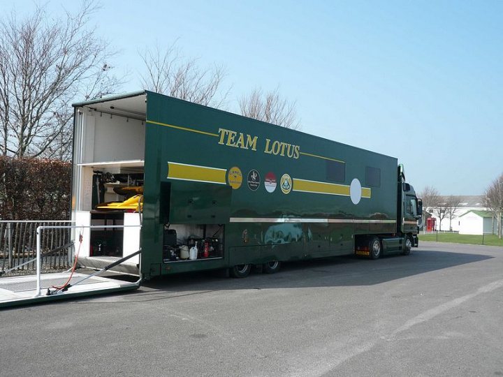 At Goodwood today..... - Page 1 - Goodwood Events - PistonHeads - This is a photo of a large, green, specially-designed truck for a sports team. The vehicle has the words "TEAM LOTUS" prominently displayed on its side, suggesting it's related to the Lotus motor racing team. The truck is parked, and the environment around it appears to be a lot or a parking area without many other structures or vehicles visible. The sky is clear, indicating favorable weather conditions.