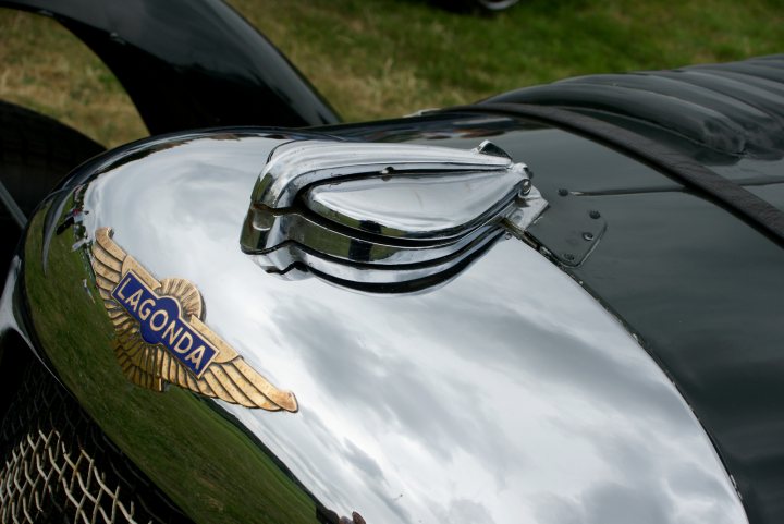 Manor June Motors Rally July Raleigh Pistonheads - The image features a vintage car, prominently displaying a front grill with "LAGONDA" inscribed in blue letters, set against a backdrop of what appears to be a clear sky. The reflective surface of the grill showcases a crisp reflection of the sky. The car's design, combined with the shine on the chrome grille, suggests a sense of elegance and craftsmanship. The overall composition of the image emphasizes the car as the central subject, showcasing its vintage design and attention to detail.