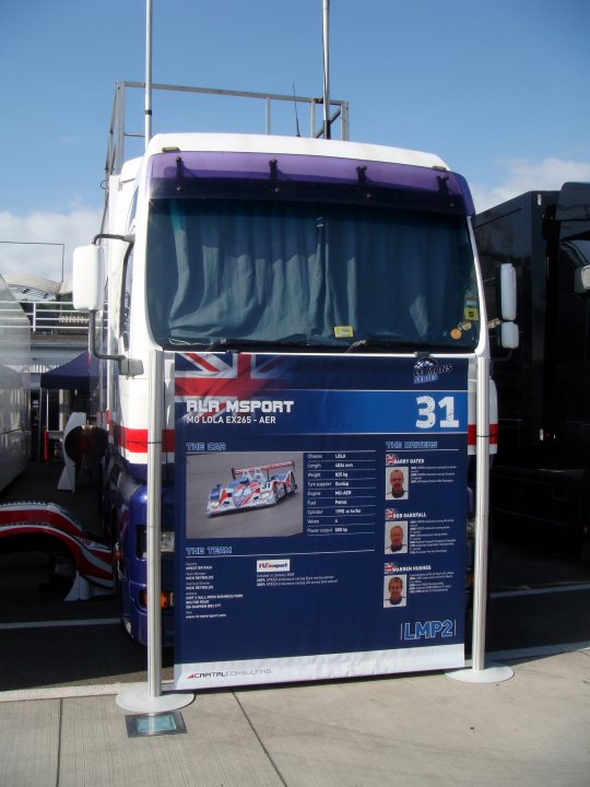 Updates Hungaroring Series Pistonheads - Since this image contains a large amount of text in various languages and is primarily of a vehicle, I can describe the prominent visible features. The vehicle appears to be a tour bus or a motor home, if it's designed for travel. It is colored white with a large number "31" prominently displayed near the back. There's also a Union Jack flag, which could indicate the vehicle is registered in the United Kingdom. The weather seems clear, as the sky is blue without clouds.