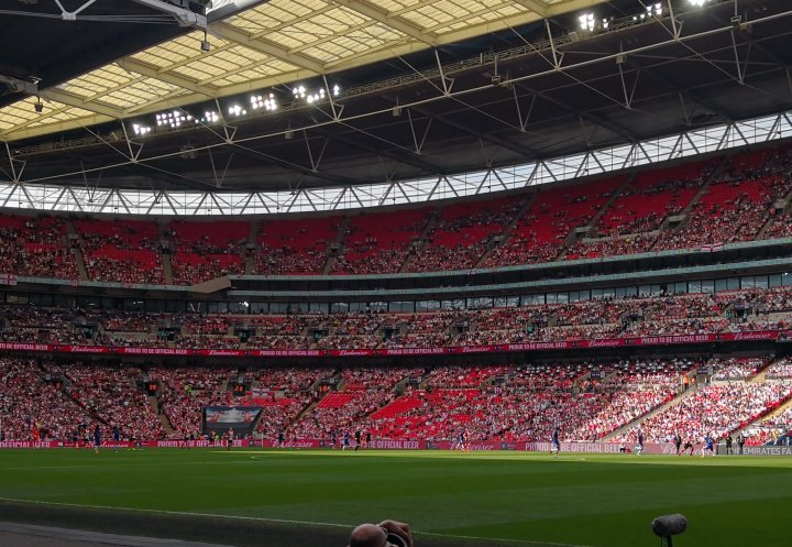 The Official Chelsea Thread [Vol 3] - Page 89 - Football - PistonHeads - The image showcases a bustling soccer arena filled with spectators. The stands are predominantly red and white, indicating fan support for opposite teams. One end of the arena has a scoreboard displaying a score for one team, although the specific game details are not visible. The atmosphere suggests excitement, with numerous fans in the stands. The overall scene is a vibrant display of a live sports event.