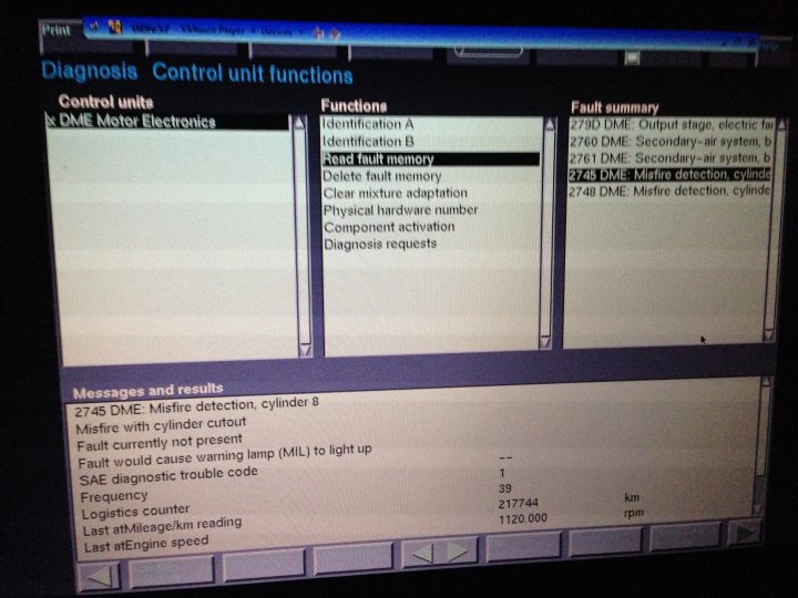 e65 745i misfire/lumpy idle when starting from cold - Page 1 - BMW General - PistonHeads - This image is a screenshot of a computer screen displaying a dialogue box in what appears to be a laptop operating system interface. The dialogue box has a dark-colored background and contains options for "Control Unit" and "Fault summary". Below that, there are tabs for "Control," "DME," and "Motor Electronics," suggesting different sections or systems. The contents seem to be technical and related to model and configuration numbers, identifiers, and error codes. The overall look is utilitarian, common to software lacking a user-friendly graphical layout. It shows an error-related message with various error codes, hardware IDs, and product codes, indicating some form of hardware diagnostics or troubleshooting.