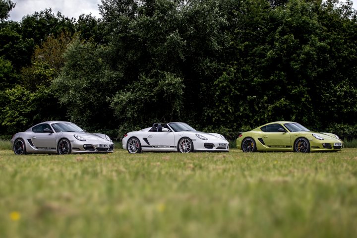A couple of cars are parked in a field - Pistonheads