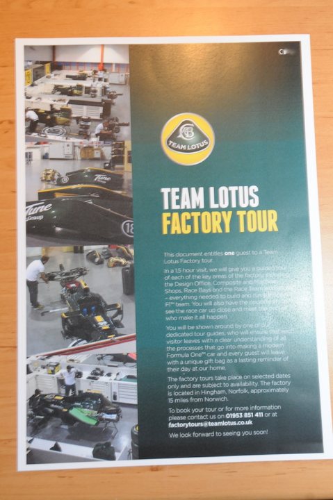 My R500 Team Lotus Special Edition - Certificate and Plaque - Page 1 - Caterham - PistonHeads - The image is of a poster or a flyer. The poster is primarily green and yellow with multiple photographs. The top photograph shows a large racing car with the number 21, signifying it is part of the Trackside Lotus Factory Tour. Below the top photograph, the graphic design includes stylized text offering information about a Team Lotus Factory Tour. The design includes a website address at the bottom, presumably for booking or more information about the tour. The style of the poster suggests it is a promotional material for a racing or automotive event. The lower section of the poster displays a factory environment, likely showcasing the production or assembly area of the Lotus factory.