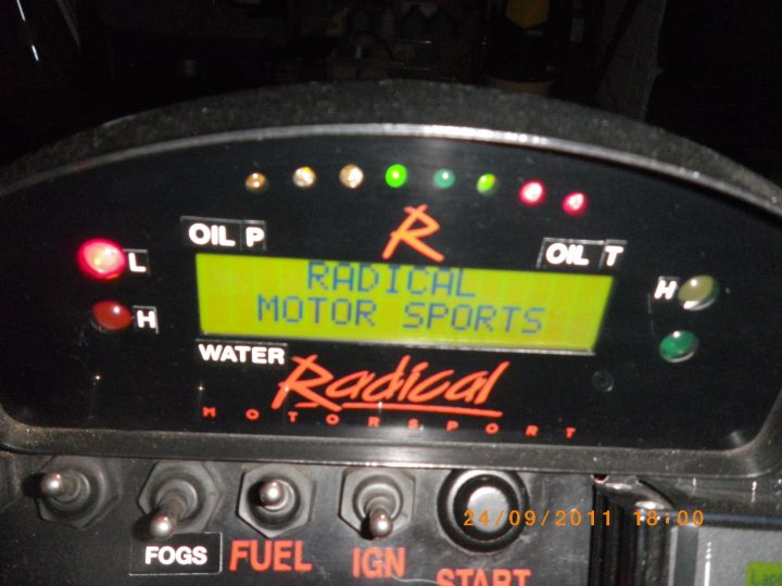 Prosport Radical Dash - Page 1 - Radical - PistonHeads - The image shows a close-up view of a digital display on a vehicle's dashboard. The display screen is illuminated and features the words "Radical Motor Sports" indicating that this photo might have been taken while on a vehicle, likely a motorcycle, that may have been modified or used for track racing. The brand "Radical" is prominent on the screen, and there are additional details such as the oil level button and indicators labeled for fuel, fogs, and ignition. The time and date stamp on the photo suggest it was taken during an event on September 24, 2011 at 8:00 PM.