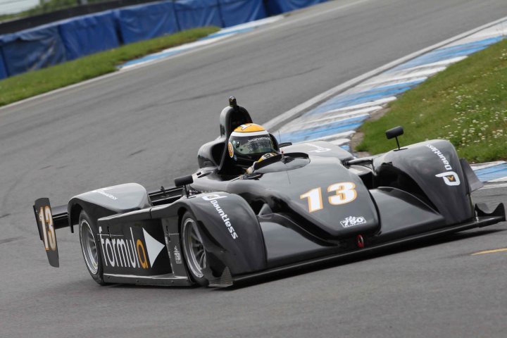 2013 - Who's racing what?  - Page 1 - UK Club Motorsport - PistonHeads - This image captures a thrilling moment on a racetrack. The main focus is a black and yellow Formula 4 race car, sporting the number 13. The car's sleek design and low profile suggest speed and agility, ready to challenge the track. The driver, securely strapped into the cockpit, is likely at full throttle, navigating the track with precision and skill. The race car, with its wings and rear spoiler, is designed for high-performance racing, Showcasing a perfect blend of technology and aerodynamics.