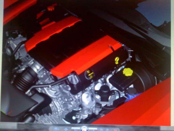 A close up of a luggage bag on the ground - Pistonheads - The image showcases an open engine bay inside a silver car. The engine components and wiring are visible, with a striking red oil cooler standing out against the metallic components. A black battery is also visible with a yellow label attached to it. The car's interior is not visible, focusing the viewer's attention solely on the engine and related parts.