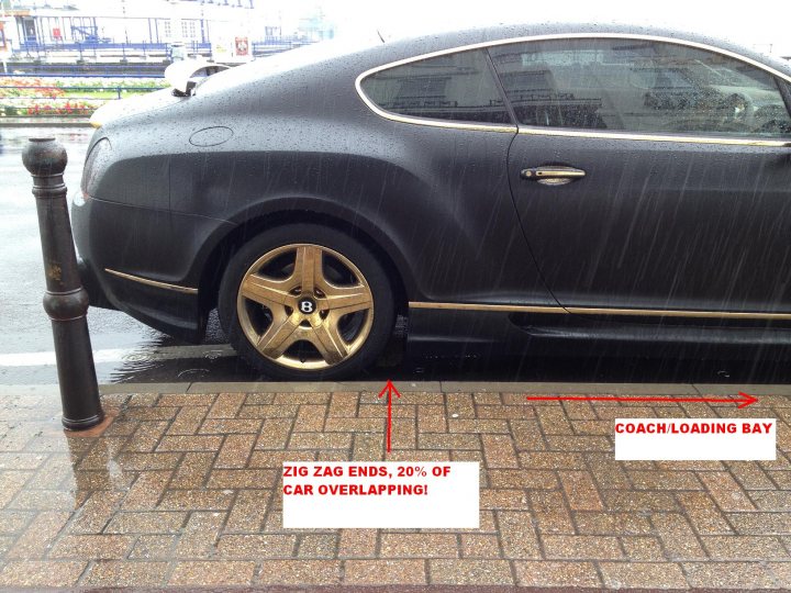 Contesting unreasonable ticket....do I stand a chance? - Page 1 - Speed, Plod & the Law - PistonHeads - The image shows a black luxury car parked on the side of a street. The car's wheel is attached with luggage, indicating that it's being used for transporting luggage, possibly for a course or event. There's a written notice taped to the driver's side door, stating the car is being loaded, likely for one or more of the trips outlined in the note. The street is wet, suggesting it has rained recently. In the background, there's a fire hydrant, reinforcing the urban setting.