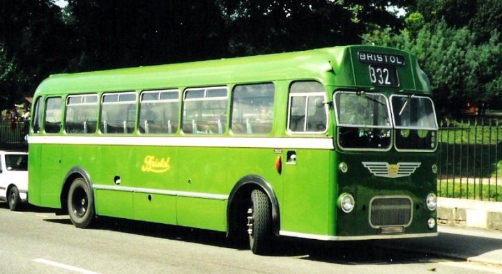 Spotted Commercials Pistonheads Classic - The image depicts an older, classic green bus with the number 332, prominently displayed on the front. It appears to be a passenger bus, possibly used for public transportation, with a vintage design that includes black tires and a large windshield. The setting seems to be on a road adjacent to a grassy area and a protective railing, suggesting this may be during the day under outdoor light. The bus is likely in operation, as it is situated on the side of the road, ready to continue its journey. Despite the age of the bus, the scene conveys a sense of nostalgia and romance associated with classic vehicles.